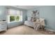 Bright bedroom with a white daybed, soft pillows, a large window, and modern light fixtures at 5044 Dockside Ct, Matthews, NC 28104