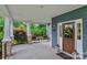 Covered porch featuring comfortable chairs, and a decorative door with natural light, perfect for relaxing at 5044 Dockside Ct, Matthews, NC 28104