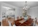 Elegant dining room with hardwood floors, a chandelier and seating for six guests at 5044 Dockside Ct, Matthews, NC 28104