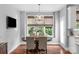 Dining room featuring a chandelier, a large window with wooded view, and hardwood floors at 5044 Dockside Ct, Matthews, NC 28104