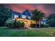 Charming exterior elevation showcasing a blue home with a welcoming front porch and manicured lawn at sunset at 5044 Dockside Ct, Matthews, NC 28104