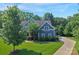Beautiful exterior elevation features a home with lush landscaping and a long driveway at 5044 Dockside Ct, Matthews, NC 28104