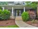 Inviting front porch with a welcoming entrance, lush landscaping, and charming details at 5044 Dockside Ct, Matthews, NC 28104