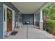 Charming covered front porch with a decorative wreath on front door at 5044 Dockside Ct, Matthews, NC 28104