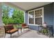 Inviting front porch with outdoor seating overlooking the manicured yard at 5044 Dockside Ct, Matthews, NC 28104