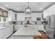 Bright kitchen with white cabinets, stainless steel appliances, large island, and modern lighting at 5044 Dockside Ct, Matthews, NC 28104
