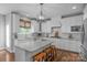 Bright kitchen featuring white cabinetry, a large island with bar seating, and stainless steel appliances at 5044 Dockside Ct, Matthews, NC 28104