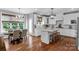 Open concept kitchen with hardwood floors, a granite island, barstools and adjacent breakfast nook at 5044 Dockside Ct, Matthews, NC 28104