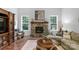 Cozy living room with stone fireplace, a large television, and a comfortable seating area at 5044 Dockside Ct, Matthews, NC 28104