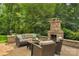 Outdoor living space with a cozy fireplace and comfortable seating at 5044 Dockside Ct, Matthews, NC 28104