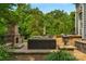 Beautiful outdoor patio features a stone fireplace, lush greenery, and ample seating for relaxing at 5044 Dockside Ct, Matthews, NC 28104