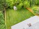 Aerial view of the fenced-in backyard with a shed and mature trees at 605 Cobb St, Lowell, NC 28098