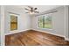 Bright bedroom with hardwood floors, two windows offering a view of the neighborhood at 605 Cobb St, Lowell, NC 28098