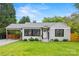 Charming home with a well-manicured lawn, a carport, and inviting curb appeal at 605 Cobb St, Lowell, NC 28098