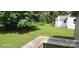 A nice backyard features a big tree and a deck at 608 E E St, Newton, NC 28658