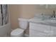 Bathroom features a white vanity, marbled countertop, modern fixtures and a shower at 608 E E St, Newton, NC 28658