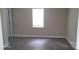 This bedroom features a window and wood-look flooring at 608 E E St, Newton, NC 28658