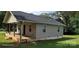 Shows the exterior side of the home with a cozy porch and steps to the yard at 608 E E St, Newton, NC 28658