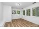 Large bedroom offering wood-look floors, neutral paint, and tons of natural light at 613 N Rhyne St, Gastonia, NC 28054