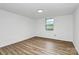 Cozy bedroom with modern vinyl floors, fresh paint, and a single window at 613 N Rhyne St, Gastonia, NC 28054