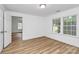 This bedroom features wood-look flooring, natural light and view to another room at 613 N Rhyne St, Gastonia, NC 28054