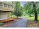 A wooden deck and driveway with a backyard shed and lush trees at 613 N Rhyne St, Gastonia, NC 28054