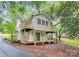 Back of home featuring two decks, a sliding door and tree coverage at 613 N Rhyne St, Gastonia, NC 28054