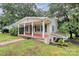 Charming home with cozy covered porch, green shutters and leafy trees at 613 N Rhyne St, Gastonia, NC 28054