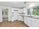 Clean, efficient kitchen featuring bright white cabinets, granite counters, and stainless sink at 613 N Rhyne St, Gastonia, NC 28054