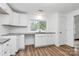 Eat-in kitchen featuring bright white cabinets and granite countertops at 613 N Rhyne St, Gastonia, NC 28054