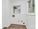 Compact laundry room with modern floors and utility connections at 613 N Rhyne St, Gastonia, NC 28054
