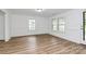 Bright living room featuring modern flooring and multiple windows for natural light at 613 N Rhyne St, Gastonia, NC 28054
