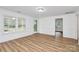 Bright living room featuring lots of natural light, crown moulding, and wood-look floors at 613 N Rhyne St, Gastonia, NC 28054