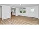 Bright living area featuring modern floors, white walls, and natural light from the windows at 613 N Rhyne St, Gastonia, NC 28054