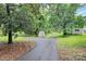 A lush backyard featuring a shed and private driveway at 613 N Rhyne St, Gastonia, NC 28054