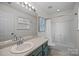 Bathroom featuring modern lighting, a tub-shower, and contemporary art at 6518 Point Comfort Ln, Charlotte, NC 28226