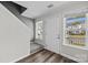 Bright entryway with hardwood floors, stairway access, and ample natural light through large windows at 6518 Point Comfort Ln, Charlotte, NC 28226