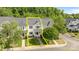 Charming multi-story townhouse featuring a well-maintained lawn, mature trees, and classic architectural details at 6518 Point Comfort Ln, Charlotte, NC 28226