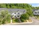 Charming multi-story townhouse featuring a well-maintained lawn, mature trees, and classic architectural details at 6518 Point Comfort Ln, Charlotte, NC 28226