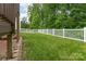 Fenced backyard with a well-maintained lawn, providing a safe and private space for outdoor activities and enjoyment at 6726 Carradale Way, Charlotte, NC 28278