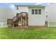 The backyard features a wooden deck with stairs leading to a brick patio and lush green grass at 6726 Carradale Way, Charlotte, NC 28278