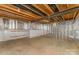 Unfinished basement with exposed ceiling and insulated walls, offering potential for future customization at 6726 Carradale Way, Charlotte, NC 28278