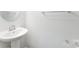 This half bathroom features a pedestal sink and modern fixtures at 6726 Carradale Way, Charlotte, NC 28278