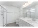 Bright bathroom featuring a double vanity, sleek fixtures, and a glass-enclosed shower with tile surround at 6726 Carradale Way, Charlotte, NC 28278
