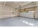 Clean and organized garage with epoxy flooring, ready for parking and storage, complete with overhead door at 6726 Carradale Way, Charlotte, NC 28278