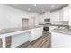 Modern kitchen featuring white cabinets, stainless steel appliances, granite countertops, and a central island at 6726 Carradale Way, Charlotte, NC 28278