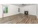 Inviting living room features wood-look floors, large windows and a cozy fireplace at 6726 Carradale Way, Charlotte, NC 28278