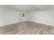 Inviting living room with wood-look floors, recessed lighting, and access to a private outdoor space at 6726 Carradale Way, Charlotte, NC 28278