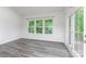 Bright living room features wood-look floors and glass doors leading to the outdoor deck at 6726 Carradale Way, Charlotte, NC 28278
