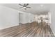 Open-concept living area with wood-look floors flows into a bright kitchen with white cabinets and an island at 6726 Carradale Way, Charlotte, NC 28278